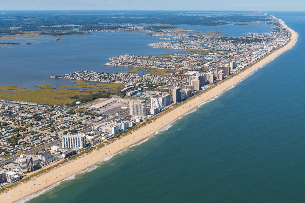 an aerial view of a beach and city