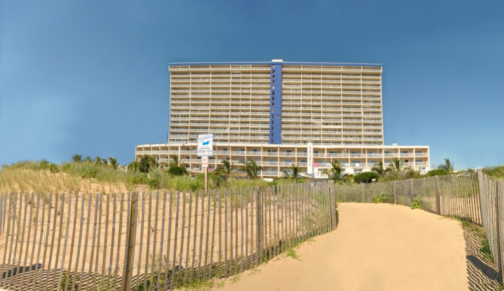 a large hotel building sitting on top of a sandy beach