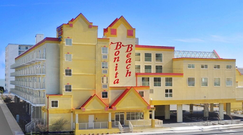 the hotel is yellow and has red trim
