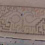an aerial view of a maze on the beach