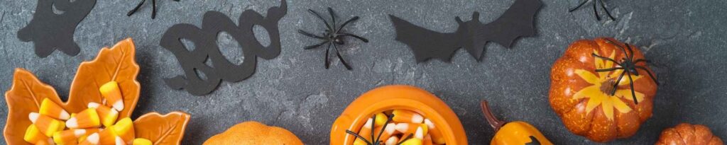 halloween decorations are arranged on a black surface