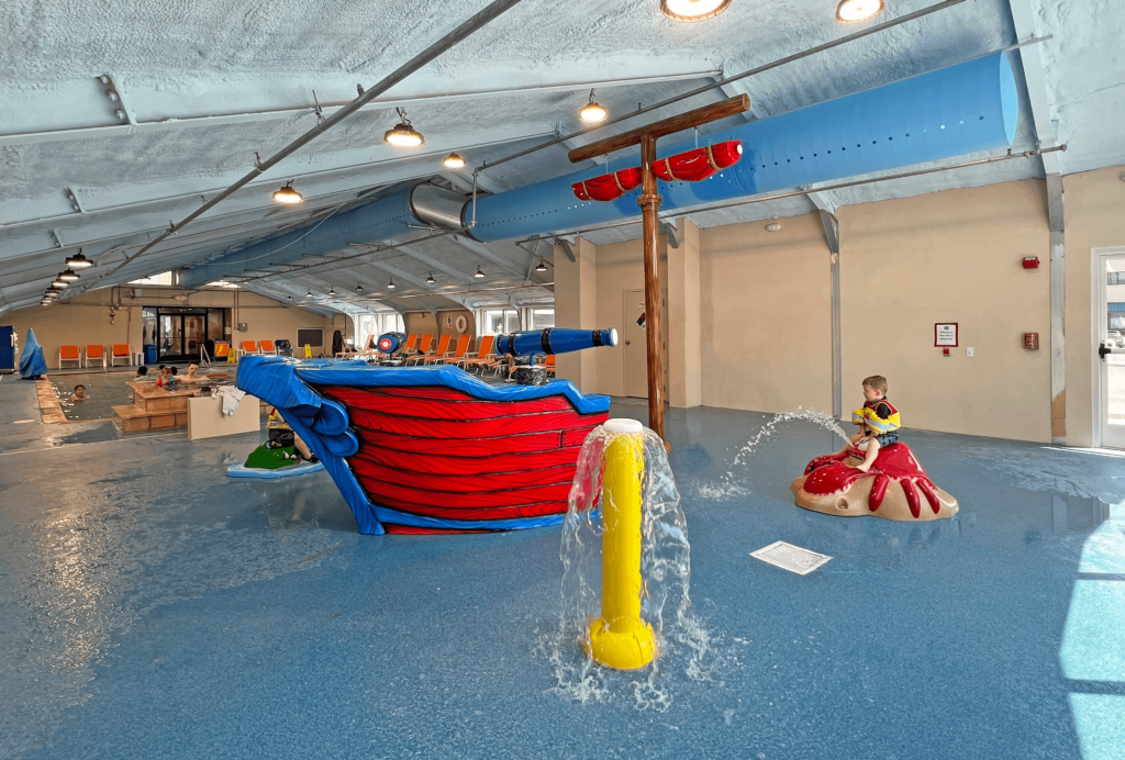 a children's play area with a slide and water feature